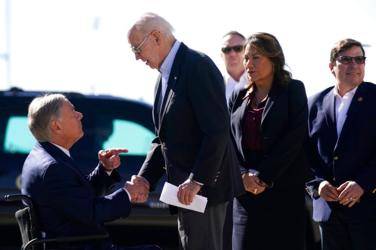 President Joe Biden shakes hands with Texas Gov. Greg Abbott.