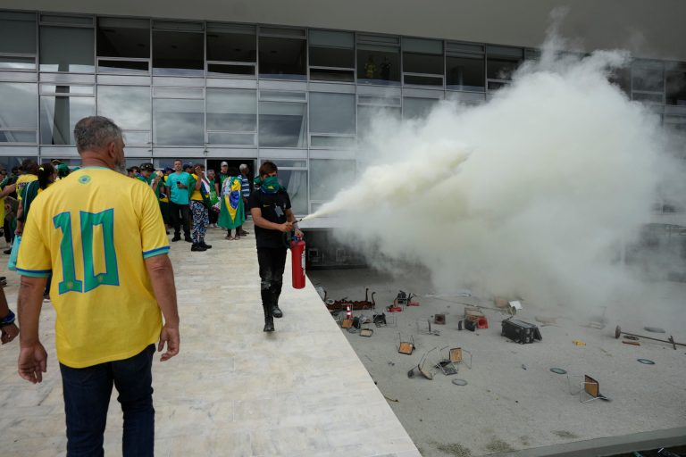 A protester, supporter of Brazil's former President Jair Bolsonaro, empties a fire extinguisher after protesters stormed Planalto Palace in Brasilia, Brazil, Sunday, Jan. 8, 2023. Planalto is the workplace of the president. 