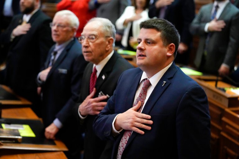 Iowa House Speaker Pat Grassley, right, stands with his grandfather U.S. Sen. Chuck Grassley, R-Iowa, during the Pledge of Allegiance on the opening day of the Iowa Legislature, Monday, Jan. 9, 2023, in Des Moines, Iowa.