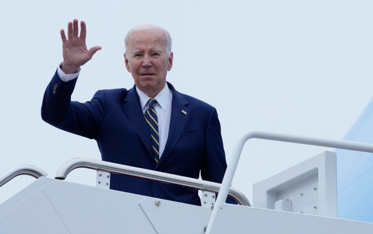 President Joe Biden waves at the top of the steps before boarding Air Force One at Andrews Air Force Base, Md., Thursday, Jan. 19, 2023.