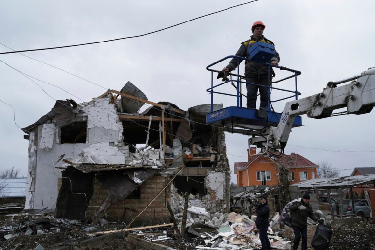 Workers check a destroyed residential area after a Russian rocket attack in Hlevakha, Kyiv region, Ukraine, Thursday, Jan. 26, 2023. 