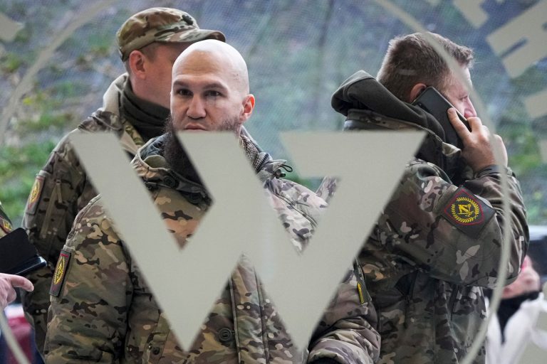 Visitors wearing military camouflage stand at the entrance of the 'PMC Wagner Centre,' which is associated with businessman and founder of the Wagner private military group Yevgeny Prigozhin, during the official opening of the office block during National Unity Day, in St. Petersburg, Russia, on Nov. 4, 2022. Russia's Wagner Group, a private military company led by Yevgeny Prigozhin, a rogue millionaire with longtime links to Russia's President Vladimir Putin, has played an increasingly visible role in the fighting in Ukraine. 
