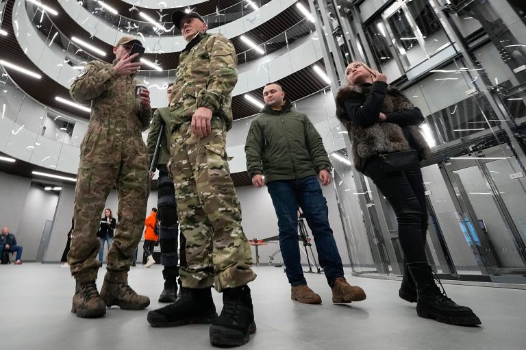 Visitors wearing military camouflage talk in the 'PMC Wagner Centre', which is associated with businessman and founder of the Wagner private military group Yevgeny Prigozhin, in St. Petersburg, Russia, on Nov. 4, 2022. 