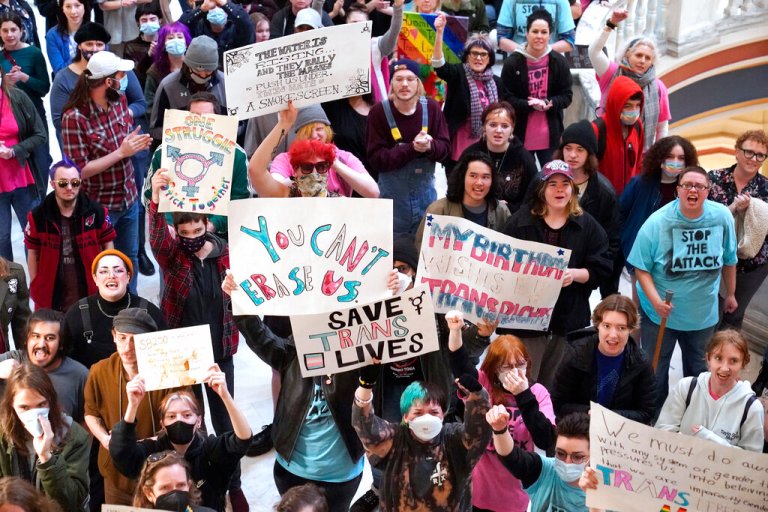 Trans rights activists protest outside the House chamber at the state Capitol before the State of the State address Monday, Feb. 6, 2023, in Oklahoma City.