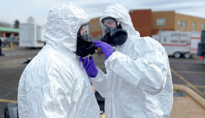 Ohio National Guard, ONG 52nd Civil Support Team members prepare to enter an incident area to assess remaining hazards with a lightweight inflatable decontamination system in East Palestine, Ohio, Tuesday, Feb. 7, 2023. 