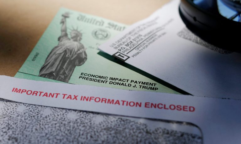 FILE - President Donald Trump's name is seen on a stimulus check issued by the IRS to help combat the adverse economic effects of the COVID-19 outbreak, on April 23, 2020, in San Antonio. (AP Photo/Eric Gay, File)