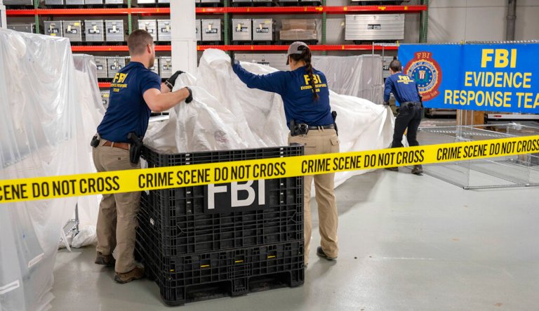 In this image provided by the FBI, FBI special agents assigned to the evidence response team process material recovered from the high altitude balloon recovered off the coast of South Carolina, Feb. 9, 2023, at the FBI laboratory in Quantico, Virginia.