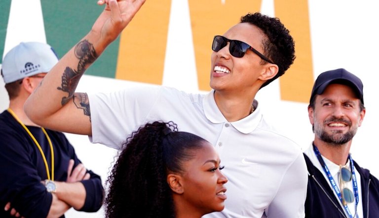 Brittney Griner waves to fans as she watches on the 16th hole during the third round of the Phoenix Open golf tournament, Saturday, Feb. 11, 2023, in Scottsdale, Ariz. (AP Photo/Darryl Webb)