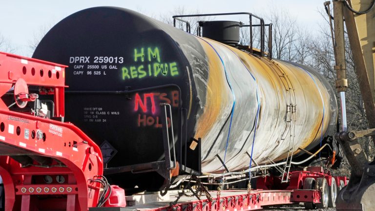 A tank car sits on a trailer as the cleanup of portions of a Norfolk Southern freight train that derailed over a week ago continues in East Palestine, Ohio, Wednesday, Feb. 15, 2023. 