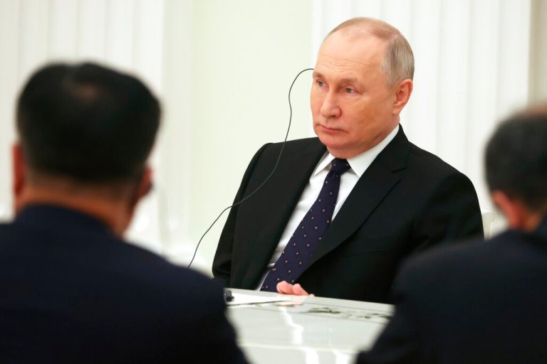 Russian President Vladimir Putin, center, listens to the Chinese Communist Party's foreign policy chief Wang Yi during their meeting at the Kremlin in Moscow, Russia, Wednesday, Feb. 22, 2023.