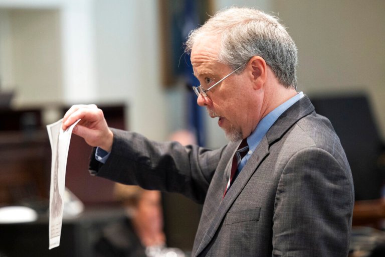 Prosecutor Creighton Waters holds up a composite sketch Alex Murdaugh helped make during closing arguments.