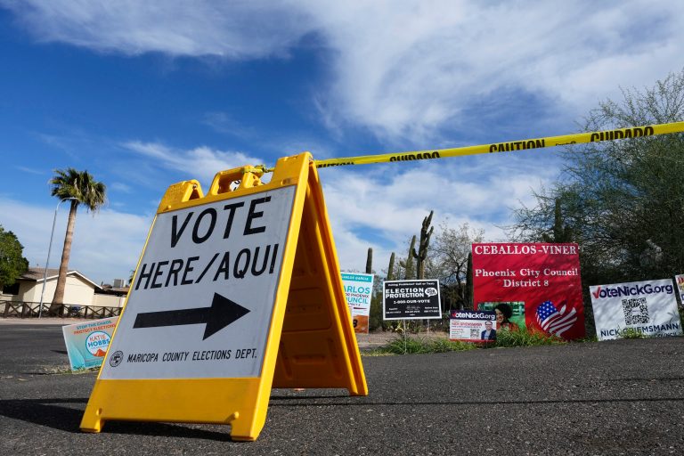 FILE - A voting sign points voters in the right direction to drop off ballots in Phoenix, Monday, Nov. 7, 2022. (AP Photo/Ross D. Franklin, File)