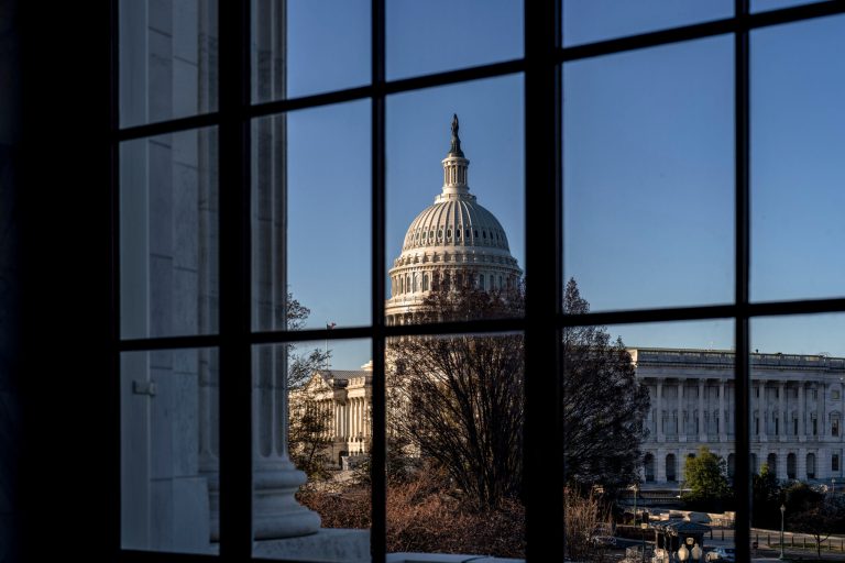 The Capitol is seen through a window in the Russell Senate Office Building in Washington, March 15, 2023.