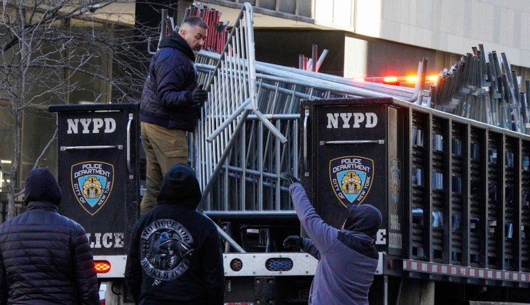 New York police officers move barricades near the courthouse ahead of former President Donald Trump's anticipated indictment on Monday, March 20, 2023, in New York. 
