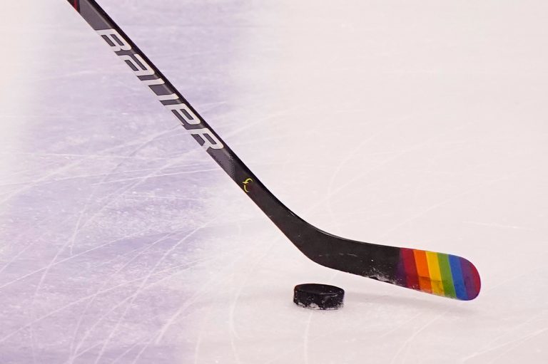 Florida Panthers center Eetu Luostarinen uses a stick with the LGBT pride flag on it before the start of an NHL hockey game against the Nashville Predators during Pride Day, Saturday, March 20, 2021, in Sunrise, Florida.