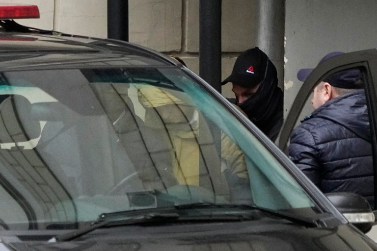 Wall Street Journal reporter Evan Gershkovich (center) is escorted by officers from the Lefortovsky court to a van, in Moscow, Russia, Thursday, March 30, 2023. Russia's top security agency says an American reporter for the Wall Street Journal has been arrested on espionage charges.