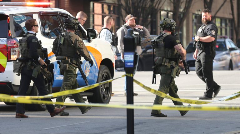 Multiple agencies arrive at a building after a shooting took place in Louisville, Ky., Monday, April 10, 2023. 