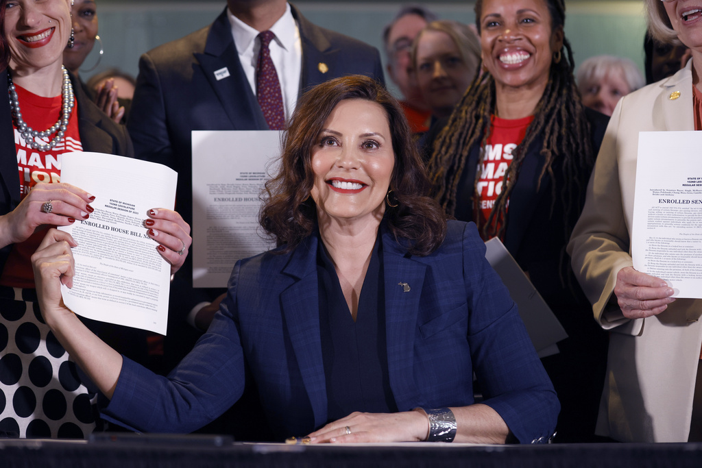 Michigan governor signs universal background check and firearm safe storage laws