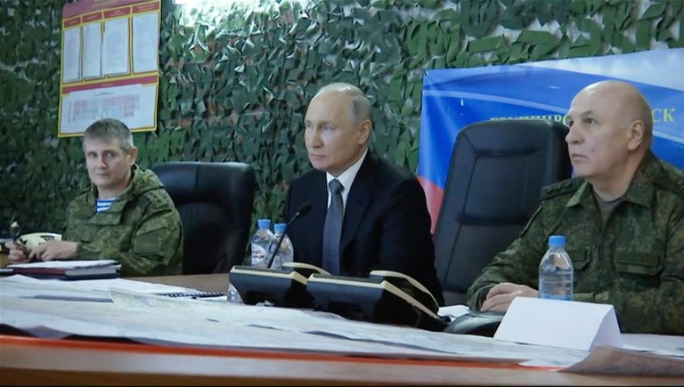 In this photo taken from video released by Russian TV Pool on Tuesday, April 18, 2023, Russian President Vladimir Putin (center) attends a meeting with commander of the grouping of troops 