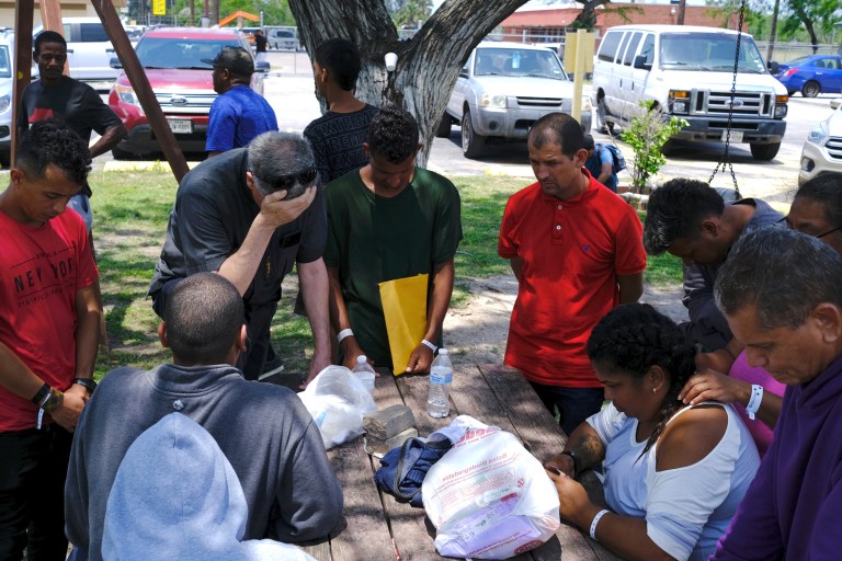 Rev. Kevin Collins, OMI, the pastor at St. Eugene de Mazenod Parish, places his hand on his forehead in prayer with others after a deadly scene took place when the driver of a Range Rover struck a group of migrants,  Sunday, May 7, 2023, along North Minnesota Avenue across from Ozanam Center, a migrant and homeless shelter in Brownsville, Texas. 