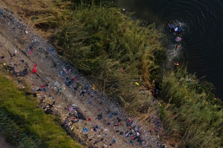 Migrants use a raft to cross the Rio Grande at the Texas-Mexico border on Thursday, May 11, 2023, in Brownsville, Texas. 
