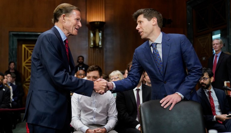Sen. Richard Blumenthal, D-Conn., left, chair of the Senate Judiciary Subcommittee on Privacy, Technology and the Law, greets OpenAI CEO Sam Altman before a hearing on artificial intelligence, Tuesday, May 16, 2023, on Capitol Hill in Washington.