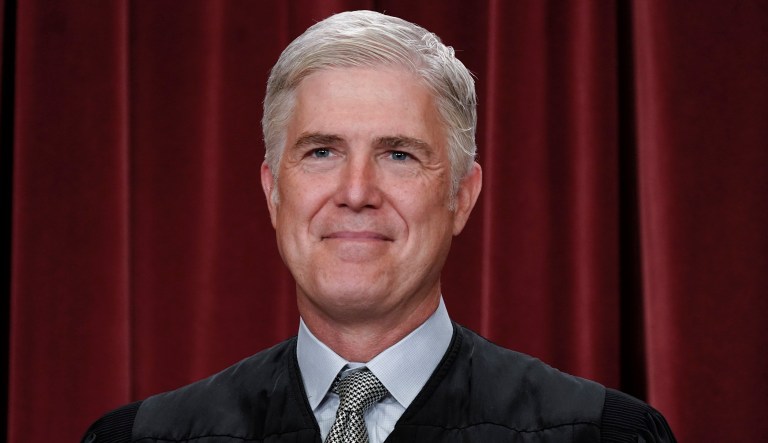 Associate Justice Neil Gorsuch joins other members of the Supreme Court as they pose for a new group portrait, at the Supreme Court building in Washington, Friday, Oct. 7, 2022.