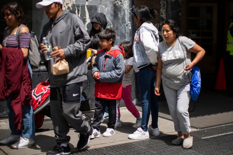 Asylum-seekers exit the Roosevelt hotel on Friday, May 19, 2023, in New York. 