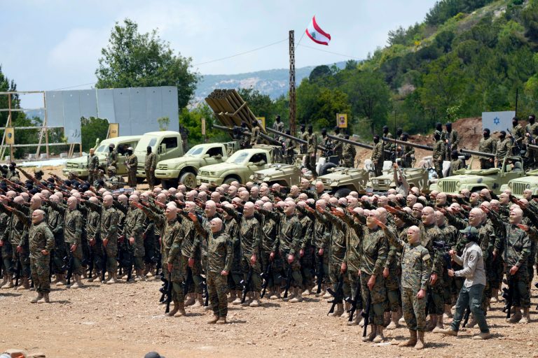 Fighters from the Lebanese militant group Hezbollah rise their hands during a training exercise in Aaramta village in the Jezzine District, southern Lebanon, Sunday, May 21, 2023. Hezbollah put on a show of force, extending a rare media invitation to one of its training sites in southern Lebanon, where its forces staged a simulated military exercise. (AP Photo/Hassan Ammar)