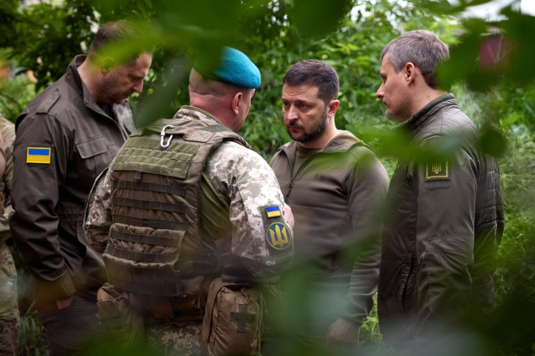 In this photo provided by the Ukrainian Presidential Press Office, Ukrainian President Volodymyr Zelenskyy listens to military commander as he visits the Donetsk region, Ukraine, Tuesday, May 23, 2023. 