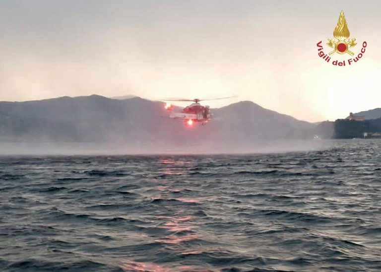 In this image released by the Italian firefighters a helicopter search for missing after a tourist boat capsized in a storm on Italy's Lago Maggiore in the northern Lombardy region, Sunday, May 28, 2023, with at least one person confirmed dead.