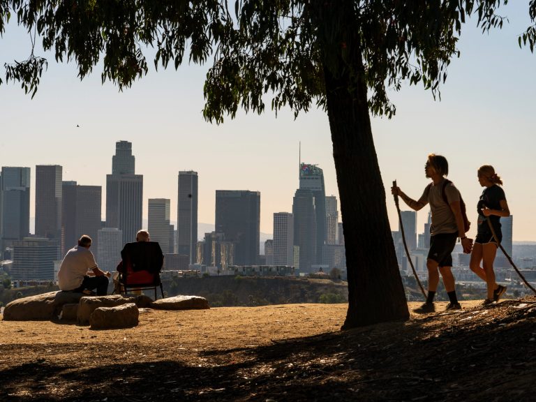 FILE - Albert Maghbouleh, far left, and Miles Santamour, 89, with Amigos de Jaibalito Foundation (ADJ) share lunch outdoors overlooking the skyline of Los Angeles on Jan. 11, 2021. (AP Photo/Damian Dovarganes, File)