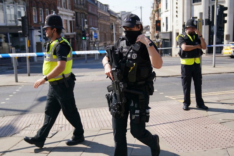 Police officers block a road in Nottingham, Britain, Tuesday, June 13, 2023. Police say three people have been found dead in the English city of Nottingham, and three others were hit by a van in linked incidents.
