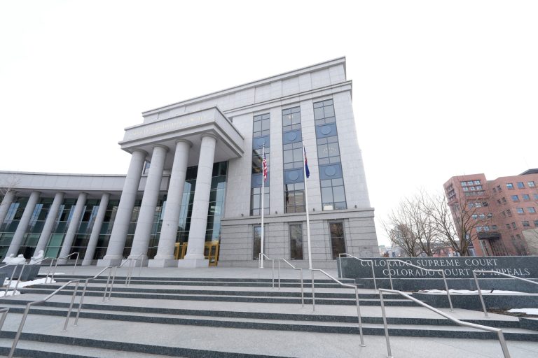 Flags stand outside the Colorado Supreme Court, on Jan. 17, 2023, in Denver.