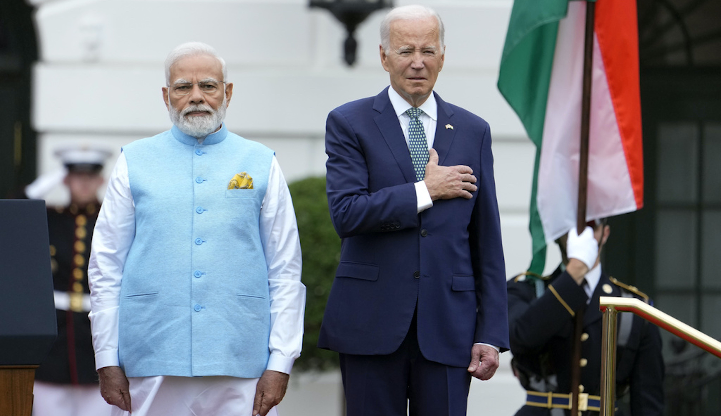 Biden slowly lowers his hand from his heart during the Indian national anthem