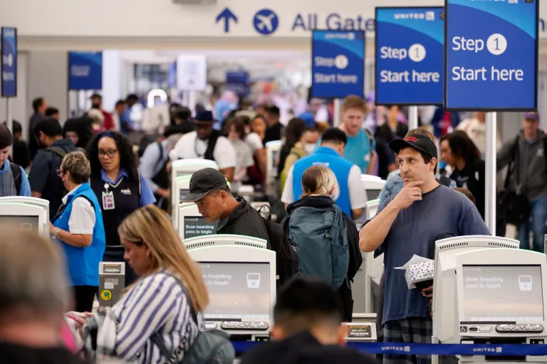 Travelers wait in line at the departure area check-in at the United Airlines terminal at Los Angeles International airport, Wednesday June 28, 2023, in Los Angeles. Travelers waited out widespread delays at U.S. airports on Tuesday, an ominous sign heading into the long July 4 holiday weekend, which is shaping up as the biggest test yet for airlines that are struggling to keep up with surging numbers of passengers. 