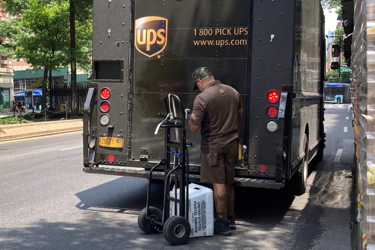 A UPS driver sorts his deliveries on New York's Upper West Side, Saturday, July 15, 2023.