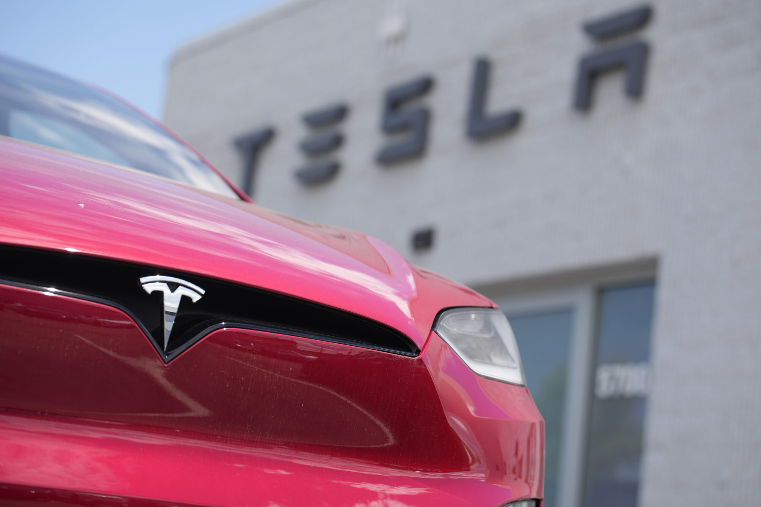 Tesla lowers price of sedan and SUV to help buyers get tax break