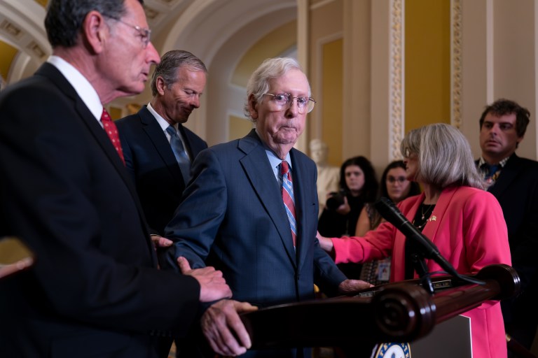 Senate Minority Leader Mitch McConnell, R-Ky., center, is helped by, from left, Sen. John Barrasso, R-Wyo., Sen. John Thune, R-S.D., and Sen. Joni Ernst, R-Iowa, after the 81-year-old GOP leader froze at the microphones as he arrived for a news conference, at the Capitol in Washington.