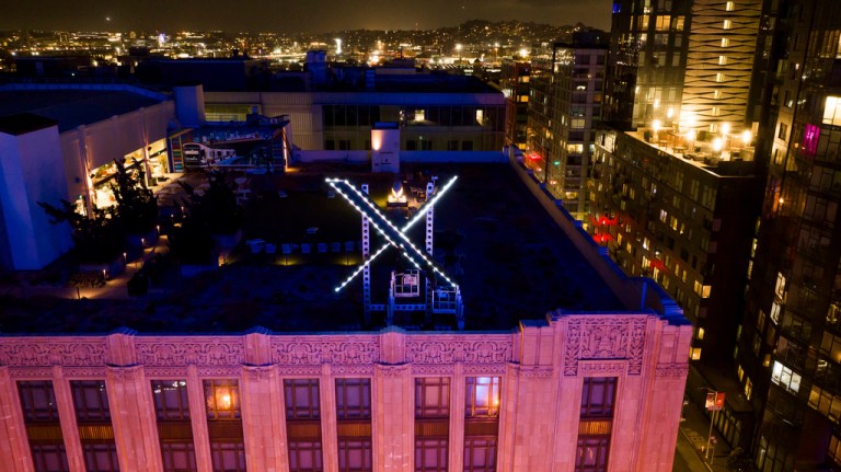 Workers install lighting on an 