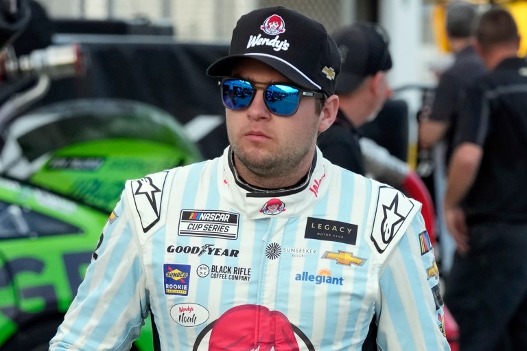 Noah Gragson walks to his garage during a practice session for the NASCAR Daytona 500 auto race at Daytona International Speedway, Friday, Feb. 17, 2023, in Daytona Beach, Florida. Gragson has been suspended indefinitely by NASCAR and Legacy Motor Club due to undisclosed activity on social media.
