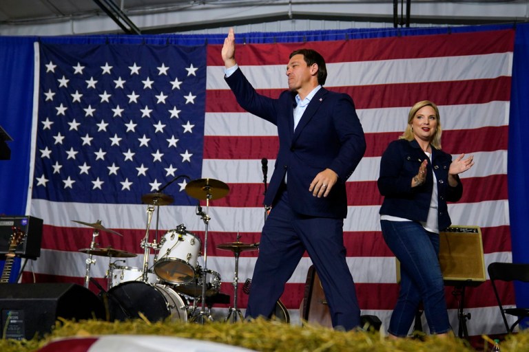 Republican presidential candidate Florida Gov. Ron DeSantis walks on stage before speaking at a fundraising event for U.S. Rep. Ashley Hinson, R-Iowa, right, Sunday, Aug. 6, 2023, in Cedar Rapids, Iowa. 
