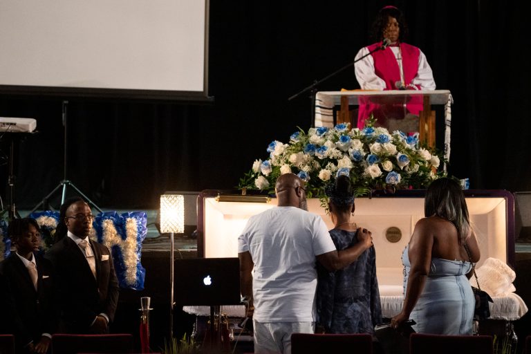 O'Shae Sibley's father Jake Kelly, center left, mother Onetha Sibley, center, and stepmother Jacqueline Kelly gather by the casket during a celebration of life for O'Shae Sibley on Tuesday, Aug. 8, 2023, at The Met Philadelphia, in Philadelphia. 