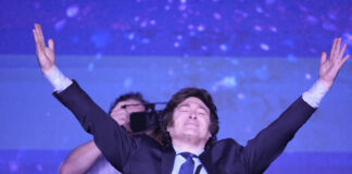 Javier Milei, the presidential candidate of the Liberty Advances coalition, smiles at his campaign headquarters after polling stations closed during primary elections in Buenos Aires, Argentina, Sunday, Aug. 13, 2023. 