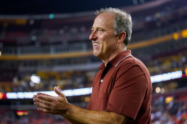 Washington Commanders owner Josh Harris applauds his team after an NFL preseason football game.