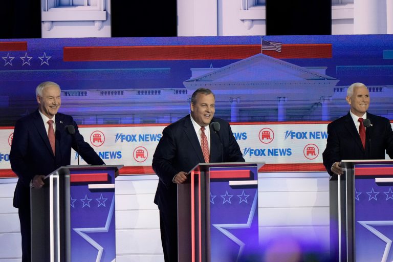 Former Arkansas Gov. Asa Hutchinson, former New Jersey Gov. Chris Christie and former Vice President Mike Pence smile at a question about UFO's during a Republican presidential primary debate hosted by Fox News on Wednesday, Aug. 23, 2023, in Milwaukee.