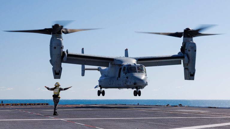 Royal Australian Navy sailor Leading Seaman Keely Hagedoorn guides a U.S. Marine Corps MV-22 Osprey during take-off and landing practice on the flight deck of HMAS Adelaide in the Whitsunday Islands off the coast of Australia during Exercise Sea Raider, Aug. 7, 2023. (SGT Andrew Sleeman/Royal Australian Navy via AP)