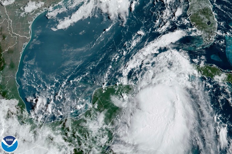 In this Monday, Aug. 28, 2023, 9:41 am ET satellite image provided by the National Oceanic and Atmospheric Administration, Tropical Storm Idalia moves between Mexico's Yucatan peninsula, left, and Cuba, right. 