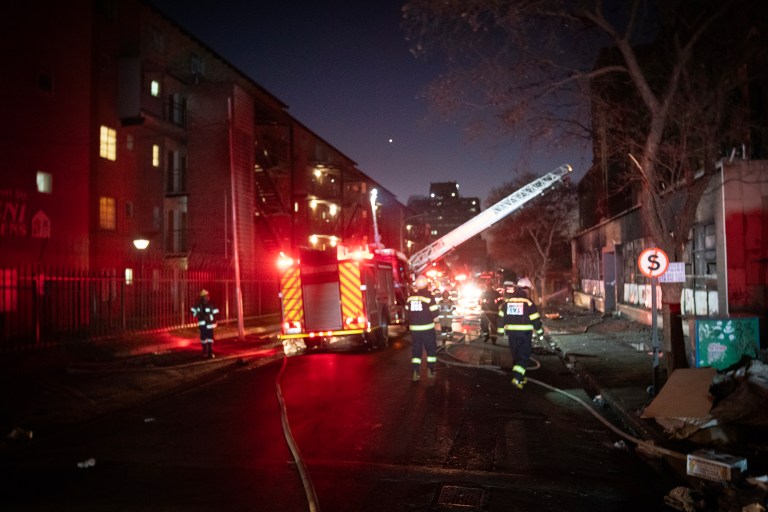 Firefighters work on the scene of a deadly blaze in downtown Johannesburg on Thursday, Aug. 31, 2023.