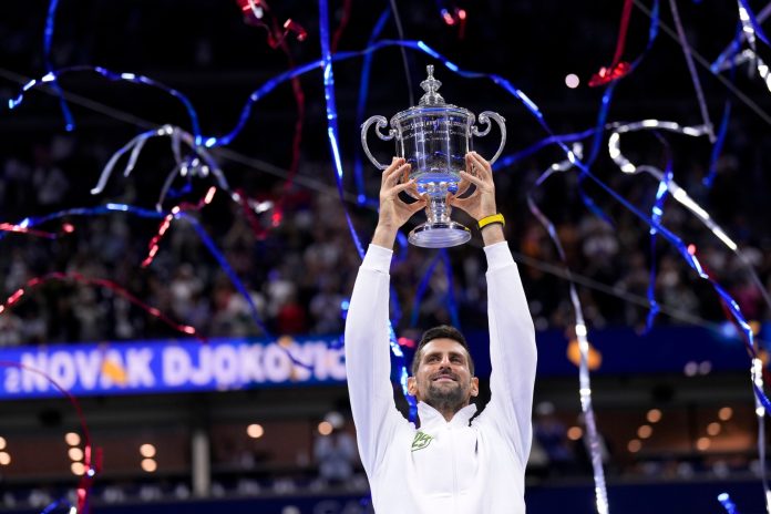 Novak Djokovic, of Serbia, holds up the championship trophy after defeating Daniil Medvedev, of Russia, in the men's singles final of the U.S. Open tennis championships, Sunday, Sept. 10, 2023, in New York.